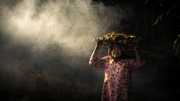woman working on a palm oil plantation